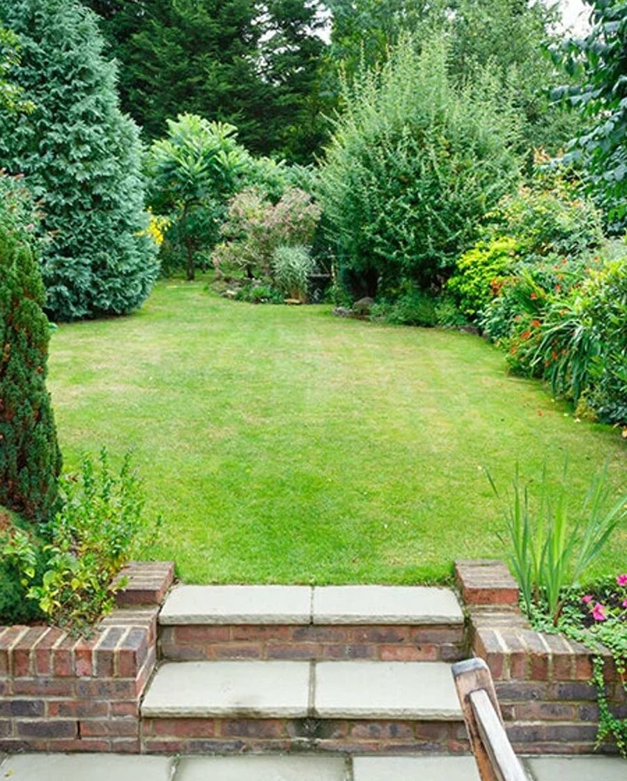 Landscaped backyard with lawn and patio